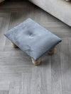 Small dark grey footrest pouffe