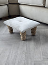 Small creamy white footrest pouffe