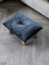 Small black footrest pouffe